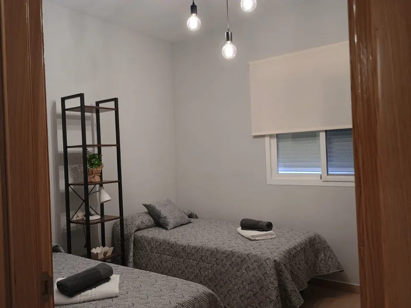 Dormitorio de dos camas individuales visto desde la puerta